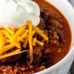 Bowl of Chili with Cornbread and Toppings